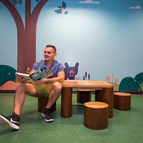 Portrait of illustrator Alexander Vidal, the artist who created the woodland murals in Curiosity Grove.