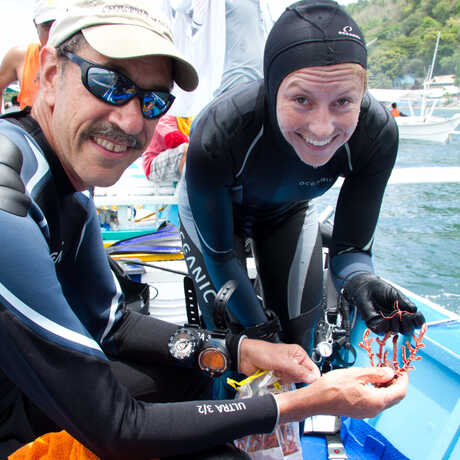 Academy scientists on a dive boat holding a specimen