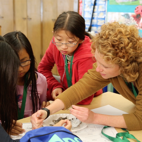 Teacher working with students on STEM